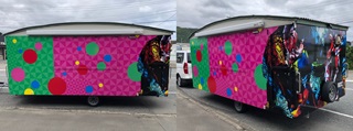 Front and side of a colorful caravan.