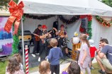 A band playing to an audience of children dancing.