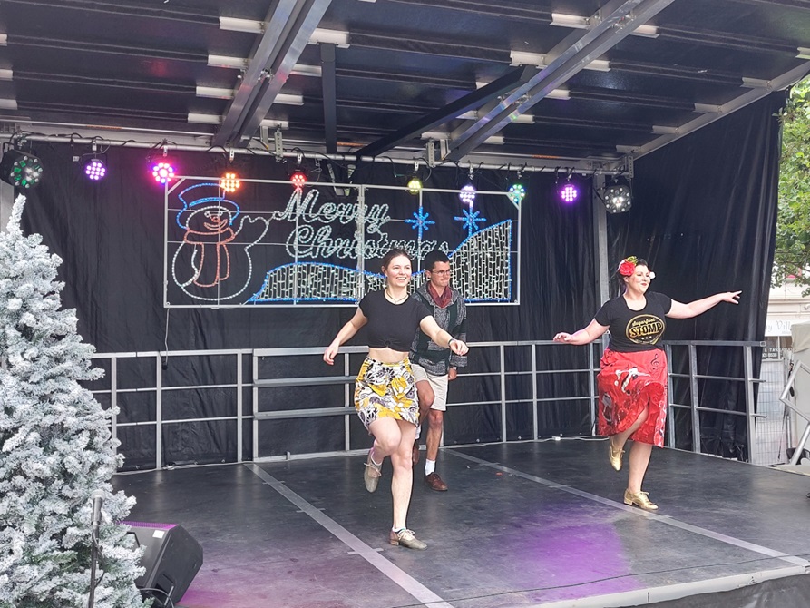 Tap dancers performing on stage at a Christmas concert.