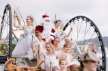 Santa on a sleigh with children dressed up as Christmas fairies.