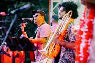 A singer and saxaphonist performing on stage.