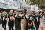 Mayor Tory Whanau waves at the Very Welly Christmas 2022 event, surrounded by five performers.
