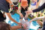 A group of children play with slime outside.
