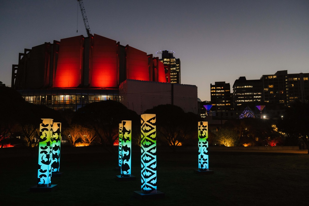 Pou Rama light sculptures, inspired by Māori land and symbols of support, on the Whairepo Lagoon lawn.