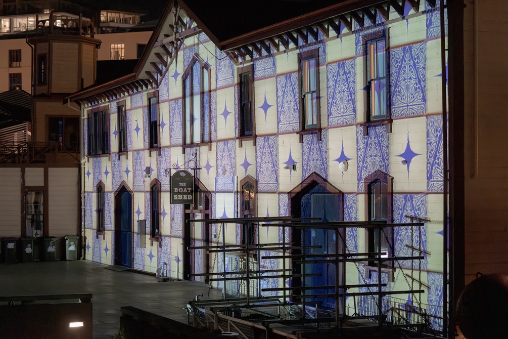 The Star Boating Club on the waterfront lit with an alternating blue and white chequer pattern.