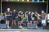 A group of Hurricanes rugby team players are interviewed on stage.