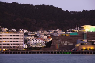 Te Papa museum on the Wellington waterfront with the words Kia kaha te Reo Māori projected onto the side of the building.