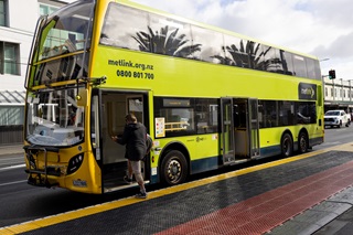 Double decker bus pulled up at bus stop in Newtown near hospital