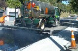 Spraying bitumen on the road.