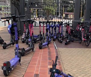 Some e-shooters parked on a footpath.