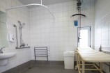 Accessible changing facilities with hoist for pool access
