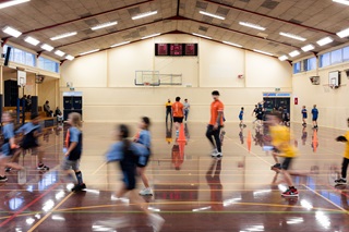 Photograph taken inside the Nairnville Recreation Centre of children playing miniball