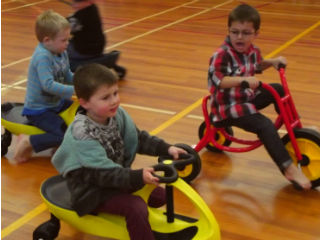 Children on tricycles.
