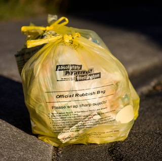 Full yellow Council rubbish bag.