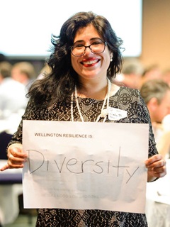 Female participant in the workshop holding a sign saying 'Wellington resilience is diversity'.