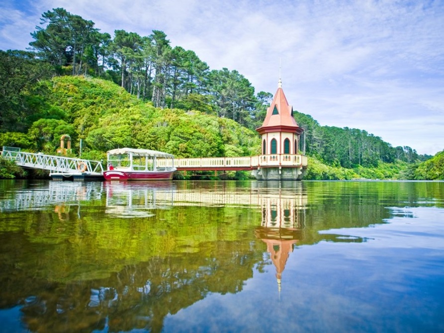 The water tower on the lower lake at Zealandia, with trees in the background.
