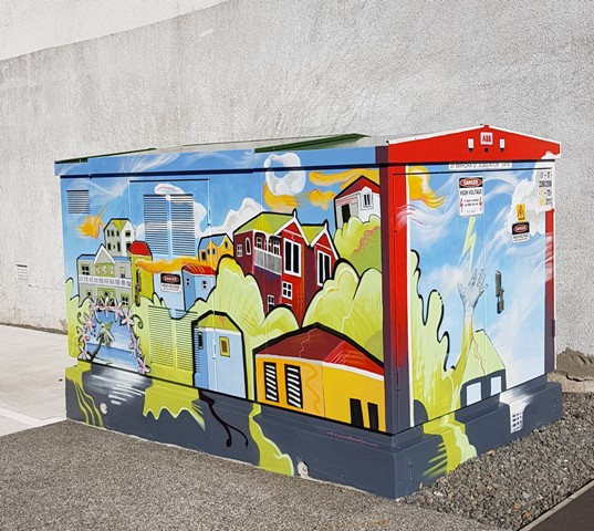 Electricity box painted in bright, colourful, streetscene.