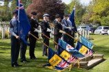 Service members in uniform hold a number of flags, including those of the Harrogate Royal British Legion, Knaresborough Royal British Legion, the Royal Air Force Association Harrogate Branch, and The Air Training Corps (cadets).
