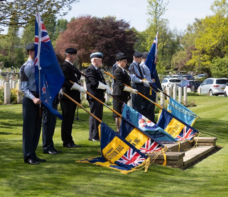 Service members in uniform hold a number of flags, including those of the Harrogate Royal British Legion, Knaresborough Royal British Legion, the Royal Air Force Association Harrogate Branch, and The Air Training Corps (cadets).