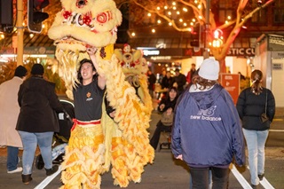 People perform inside a Chinese dragon at a street festival in Wellington.