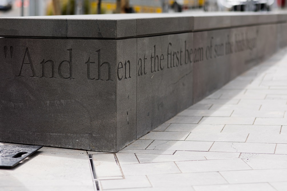 Detail of concrete kerb showing inscribed text.