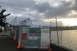 Fencing and cones surrounding a portaloo and scaffolding on Oriental Bay.