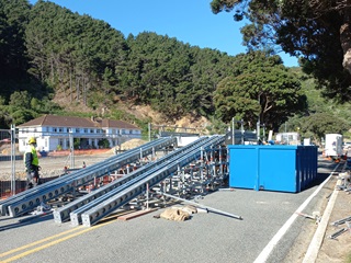 A ramp constructed from scaffolding which allows a vehicle to drive up to a platform to be cleaned.