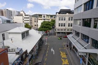 Looking down on Garret Street, office buildings can be seen to the right and shops on the left.