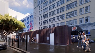 Artist's impression of the Inglewood Place toilets showing six doors, in a brown wooden-looking building. The toilets look small compared to the tall building behind them. You can also see a tree to the left.