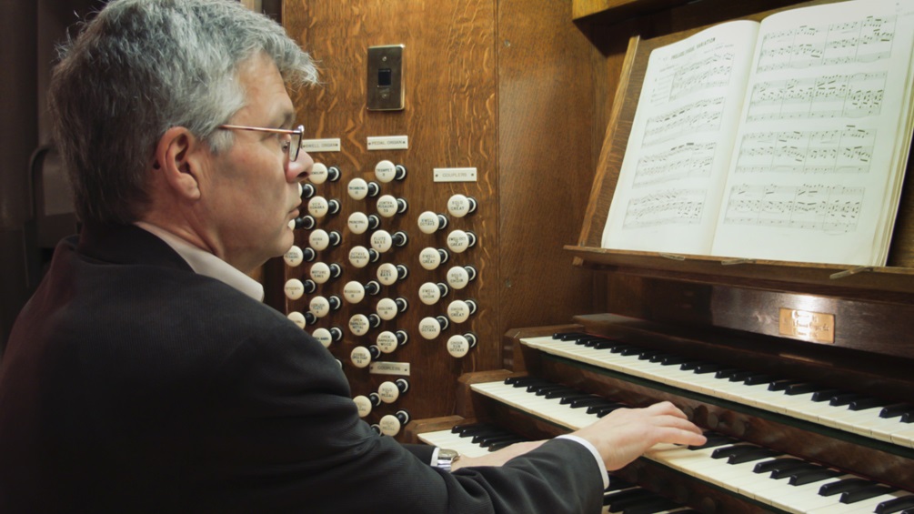 Organist Douglas Mews plays the organ for the last time before it gets dismantled.