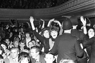 Screaming fans held back by policemen at a Beatles concert at Wellington Town Hall in June, 1964.