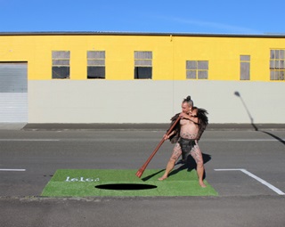 A park installation featuring a man in a traditional Maori outfit.