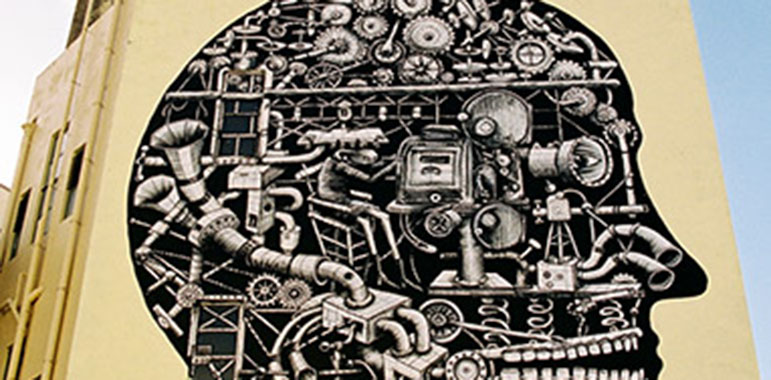 Black and white mural in illustrative style showing projector parts and forming a head shape.
