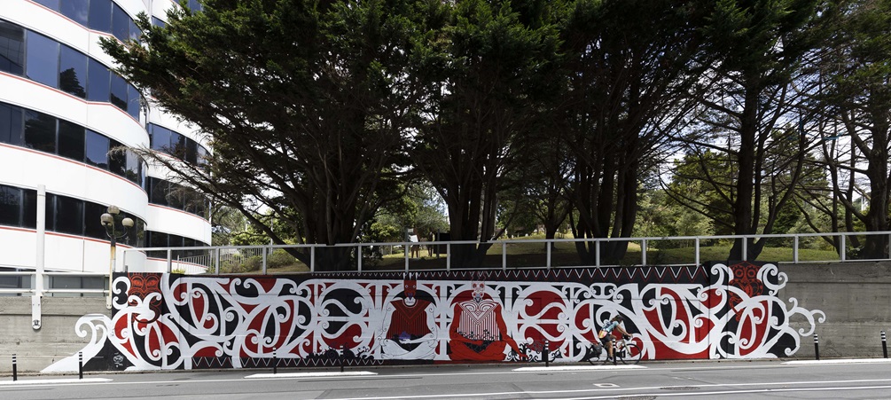 Large mural on Bowen Street, red, white and black with te reo designs.