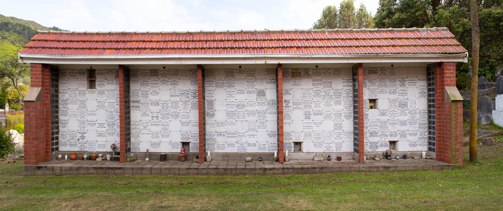 A wall of white memorial niches that look like tiles.
