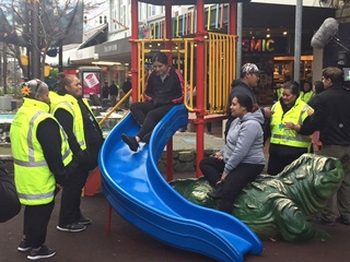 A group of Pasifika Patrollers talking to members of the public in Cuba Street.
