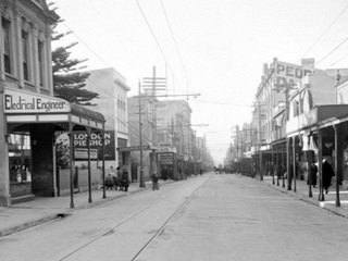 Upper Cuba Street circa 1927 with 126 Cuba Street in the background on the left - a billboard advertising pies is on its side (photograph by Crown Studios).
