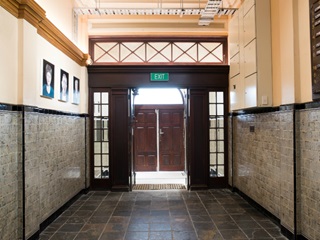 Inside the entryway of Wellington Trades Hall, facing back towards the front door.