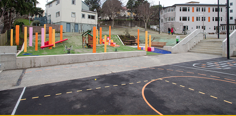 Playground and basketball half-court at Berkeley Dallard Apartments.