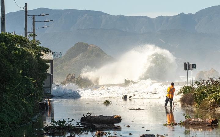 A large wave crashes onto Ōwhiro Bay during an extreme weather event.