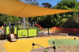 Cummings Park play area, including roundabout, slide, and sun shade.