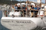 A group of people on board of the Robert C. Seamans scientific research vessel.