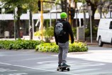 Person ridding a skate board in Lambton Quay.
