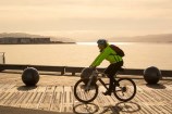 A cyclist on Wellington waterfront at sunset.