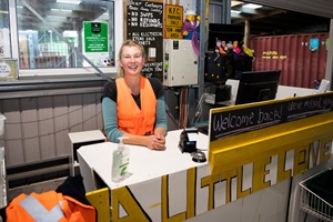 A Tip Shop staff member welcomes customers.