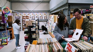 Tip Shop customers browse the items on offer, including books and records.
