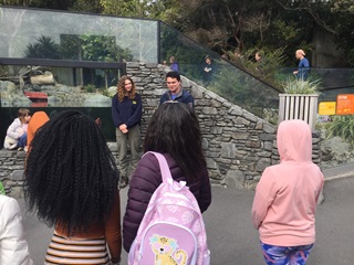 Rangers Anna and Zach welcome a group from ChangeMakers to Wellington Zoo, next to the otter enclosure. 