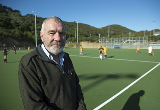 Peter Hemsley in front of a Council artificial turf. 