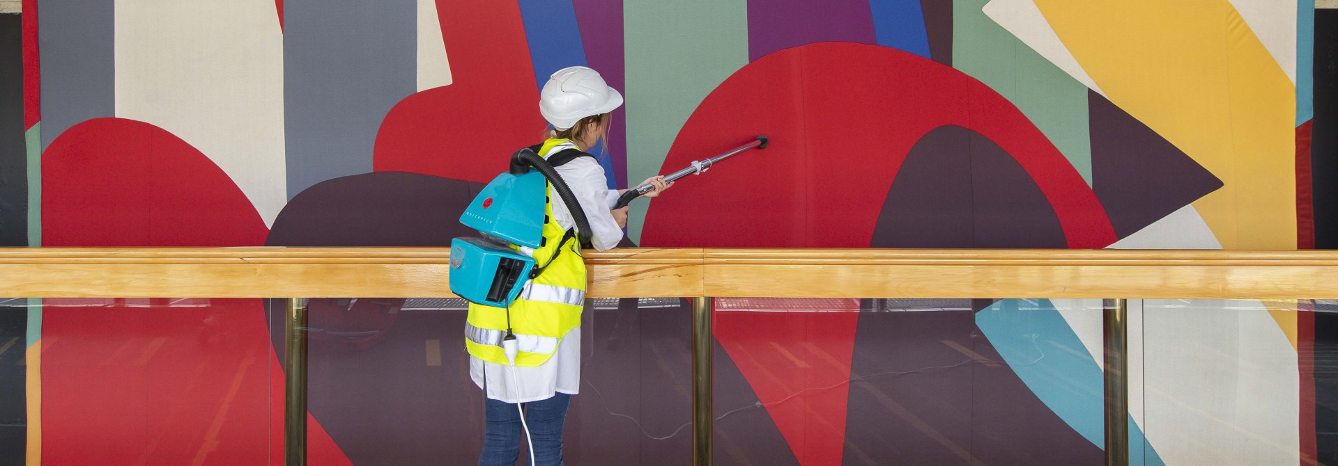 A large textile artwork by Gordon Crook being cleaned. 