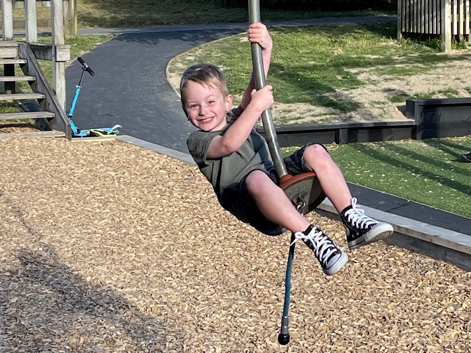Four-year-old Jax with a big smile on his face as he sails on a flying fox at the revamped Karori park.